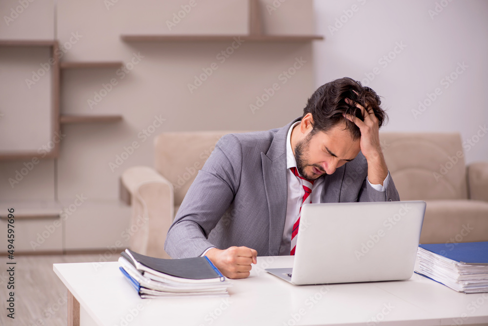 Young male employee working from home during pandemic Young male employee working from home during pandemic