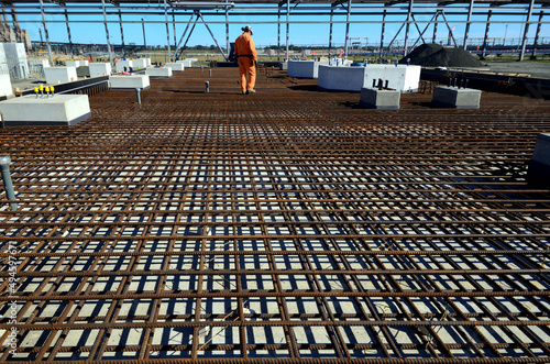 concrete formation work prior to building site in Victorian refinery onsite worker checks build.
 photo