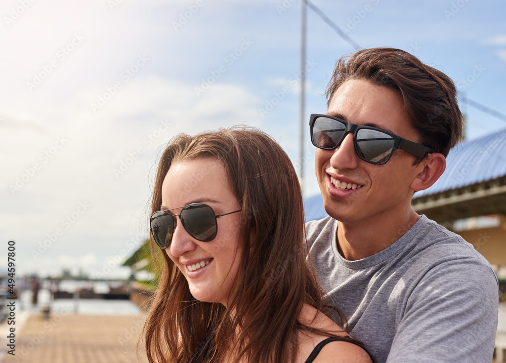 Enjoying a day in paradise. Shot of an affectionate young couple standing together outside. Enjoying a day in paradise. Shot of an affectionate young couple standing together outside.