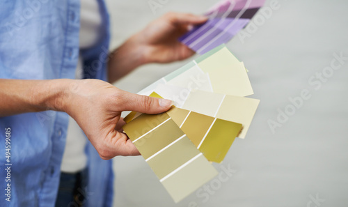 Shes got the right swatch for you. Shot of a woman fanning out color swatches.