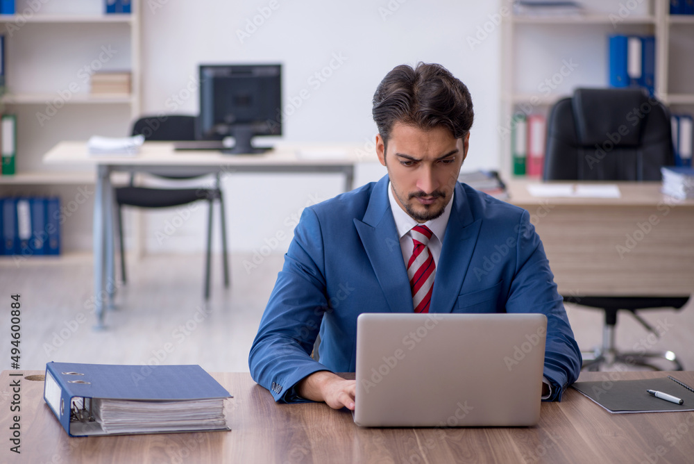 Young male employee working in the office Young male employee working in the office