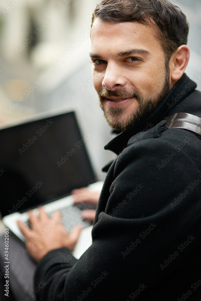Whether for work or play, Im connected all the time. Shot of a handsome young man using a laptop outside. Whether for work or play, Im connected all the time. Shot of a handsome young man using a laptop outside.