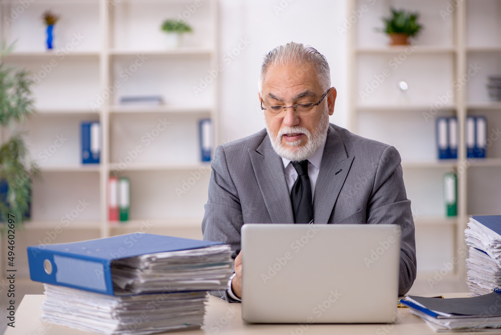 Old male employee and too much work in the office Old male employee and too much work in the office