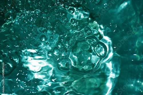 Clear green sea surface with sparkling bubbles, concept for refreshing feeling background.