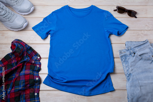 Unisex blue T-shirt mockup with trainers and jeans