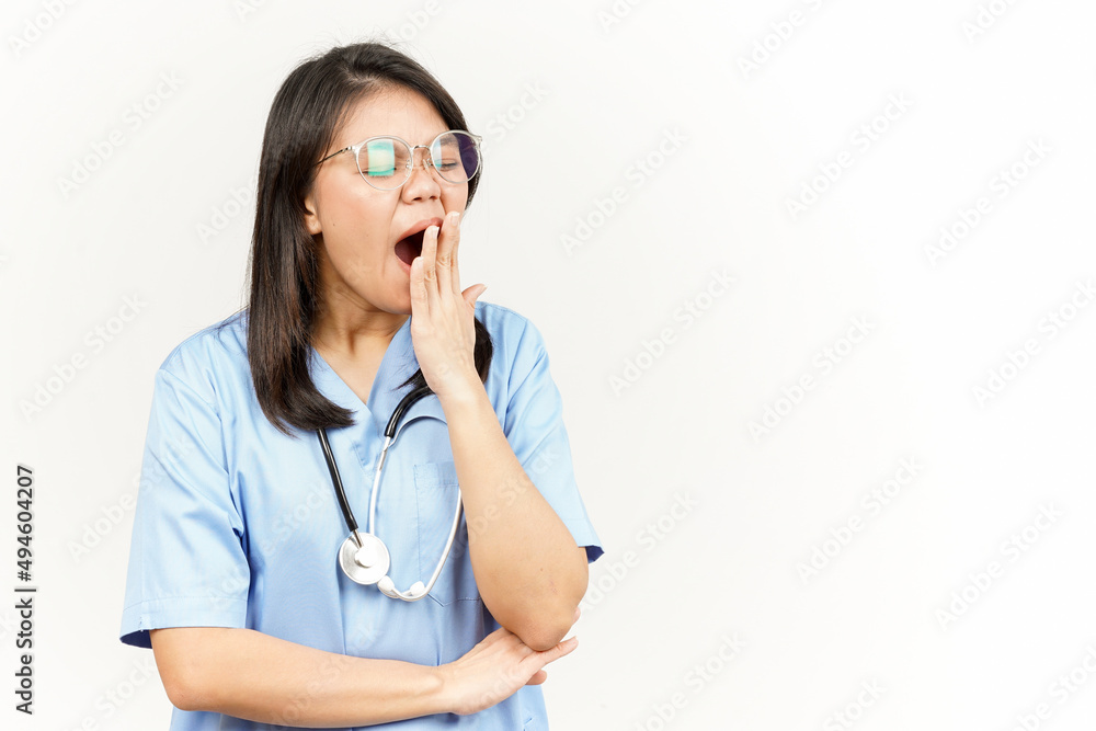 Yawning Of Asian Young Doctor Isolated On White Background Yawning Of Asian Young Doctor Isolated On White Background