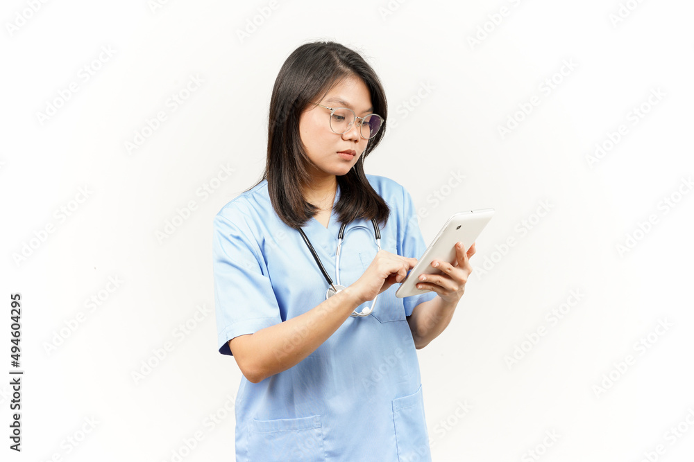 Holding and Using Tablet Of Asian Young Doctor Isolated On White Background Holding and Using Tablet Of Asian Young Doctor Isolated On White Background