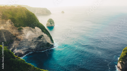 aerial view of tropical beach with high cliffs and blue sea water in the morning, Nusa Penida island Bali