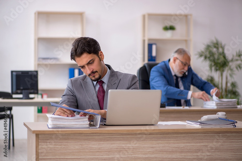 Two male colleagues working in the office