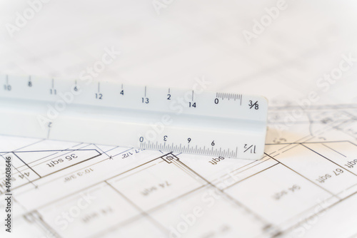 Architectural Scale Ruler with paper blueprints plans for new building © primestockphotograpy