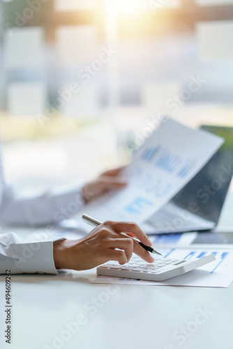 Businesswoman sitting planning analyze investment and marketing on the desk in the office.