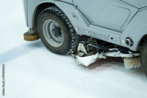 Closeup of an electric operated Ice resurfacer machine cleaning the ice surface photo