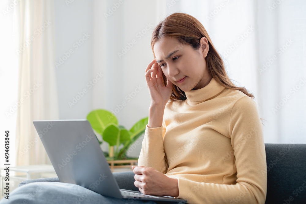 Frustrated stressed business woman sitting on sofa at home. Frustrated stressed business woman sitting on sofa at home.
