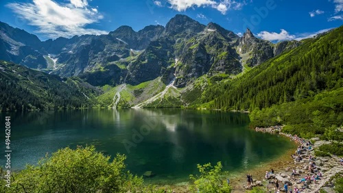 Poland mountains morskie oko Eye of the Sea a lake surrounded by mountains top peek views clear clean lake timelapse white clouds shadows floating by near town of zakopane in Tatra Mountains