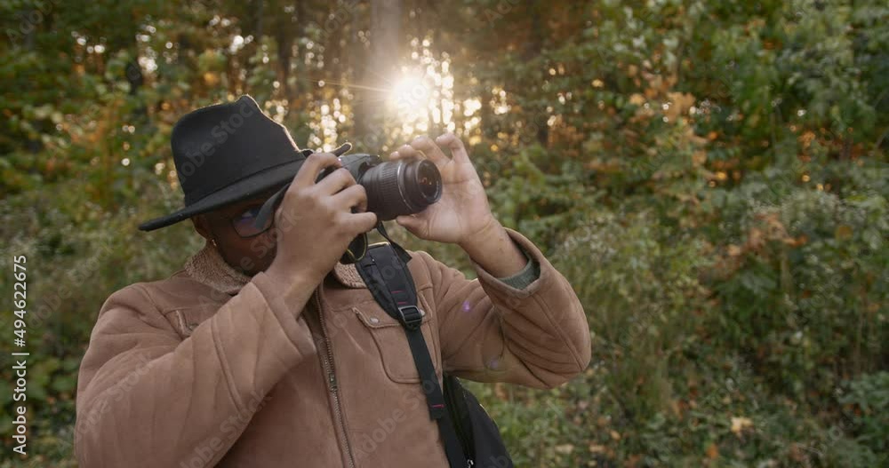 A young black traveler shoots the forest on camera A young black traveler shoots the forest on camera