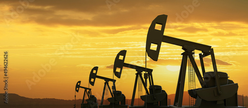 Oil pump jack in a row drilling, sunset sky background. Oil and natural gas industry. 3d render