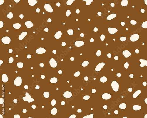  Deer skin texture seamless pattern. Perfect use for fabric, wallpaper, home decor. Abstract spots. Vector background on brown surface