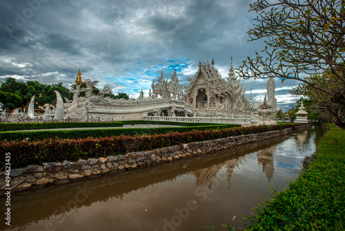 background Wat Rong Khun The White Temple and pond with fish, in Chiang Rai, Thailand © bangprik