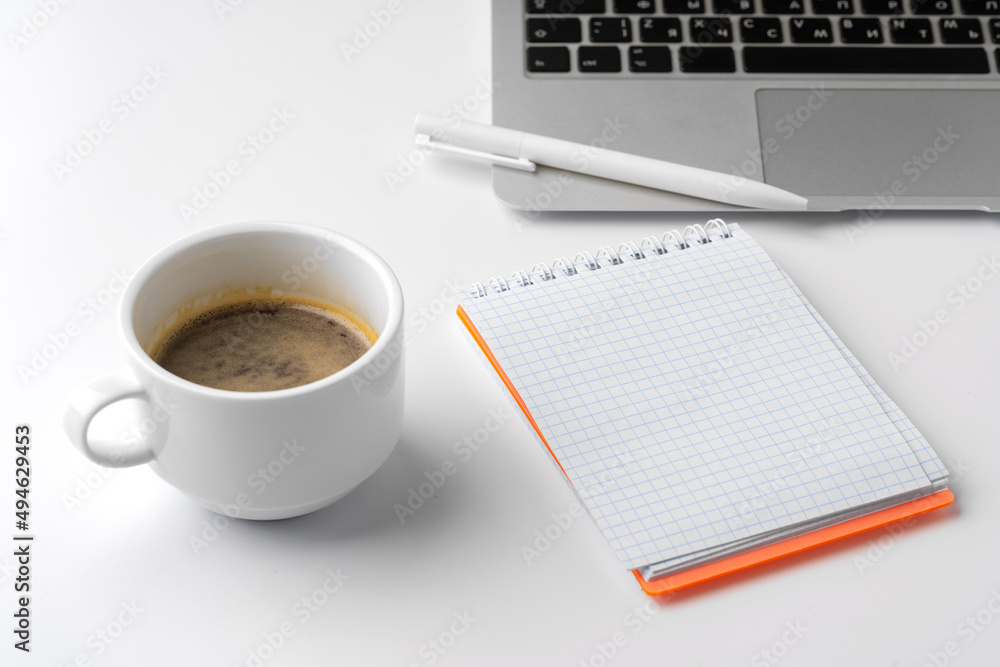Office desk with laptop, blank notebook and coffee cup Office desk with laptop, blank notebook and coffee cup