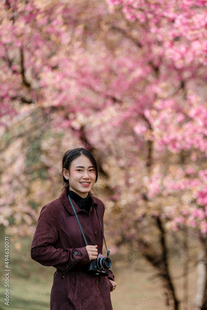 girl with bright pink cherry blossoms in winter girl with bright pink cherry blossoms in winter