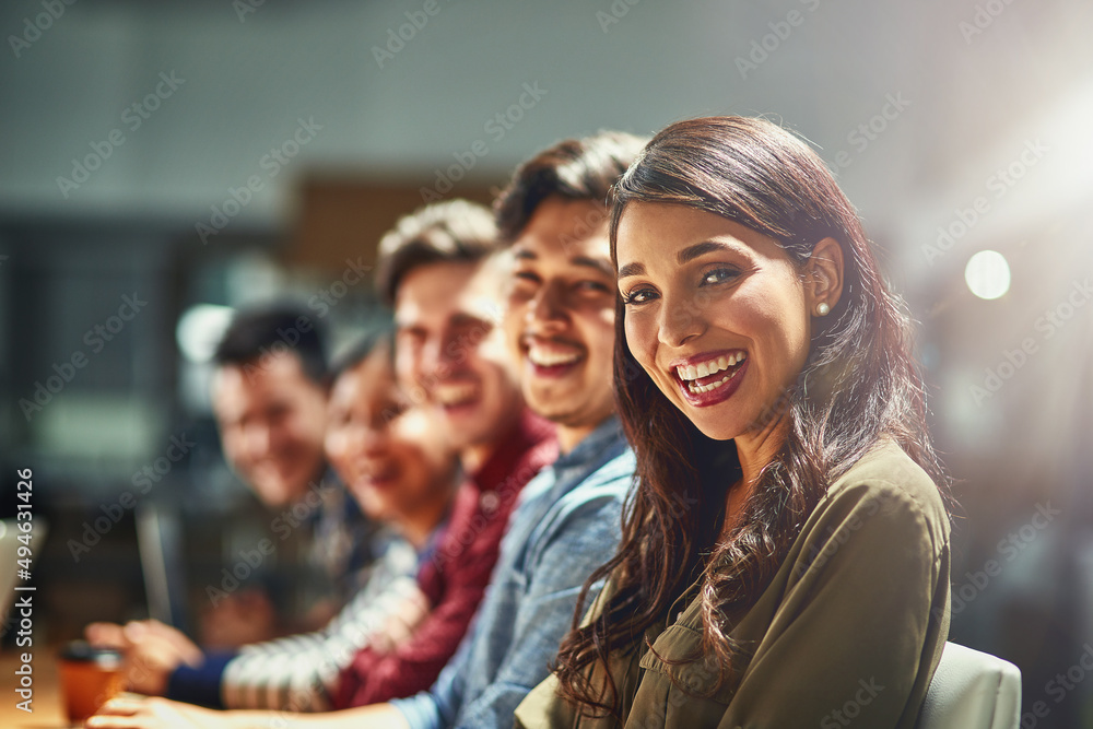 Together, well revolutionise the industry. Portrait of a team of designers sitting in a meeting together.