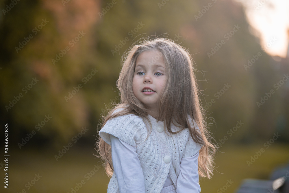 Beautiful little child girl walking in a park. High quality photo