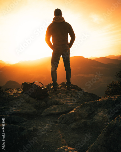 silhouette of a person standing on the top of mountain