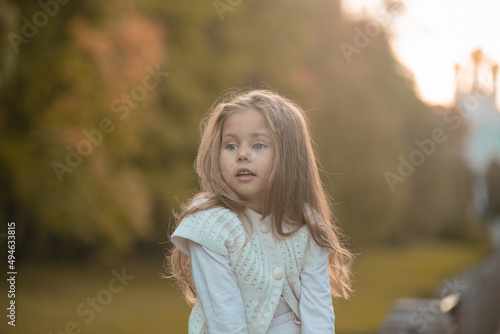 Beautiful little child girl walking in a park. High quality photo