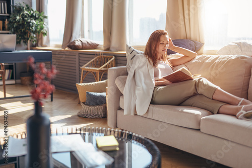 Reading literature. Woman at home with a book photo