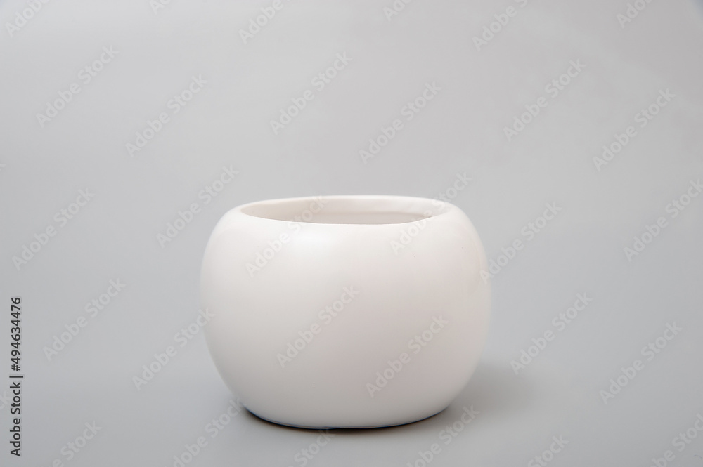 White spherical vase on a gray background. Minimalism. Design. White spherical vase on a gray background. Minimalism. Design.