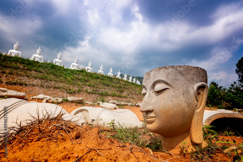 Many Buddha statues on the mountain with damage