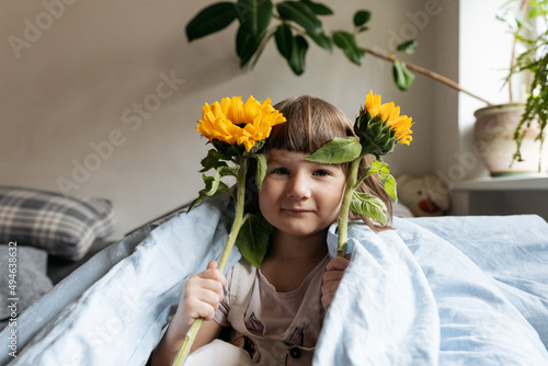 Wallpaper Mural Portrait of a toddler girl holding sunflowers Torontodigital.ca