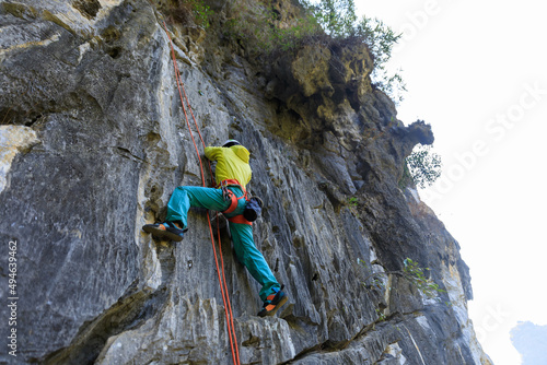 Female rock climber on the cliff
