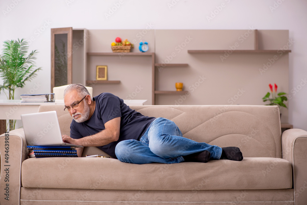 Old male employee working from home during pandemic Old male employee working from home during pandemic