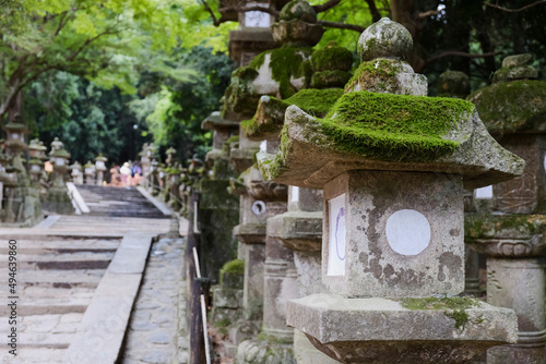 Detail of a stone lantern with moss next to the Steps of Nara Park in Kyoto, Japan