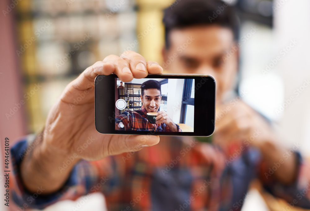 Coffee shop selfie. Cropped shot of a handsome young man taking a selfie.