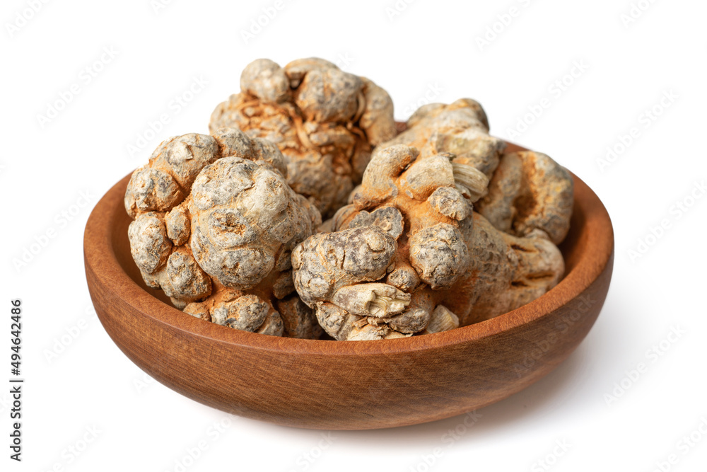 Dried notoginseng roots in the wooden bowl, isolated on the white background. Dried notoginseng roots in the wooden bowl, isolated on the white background.