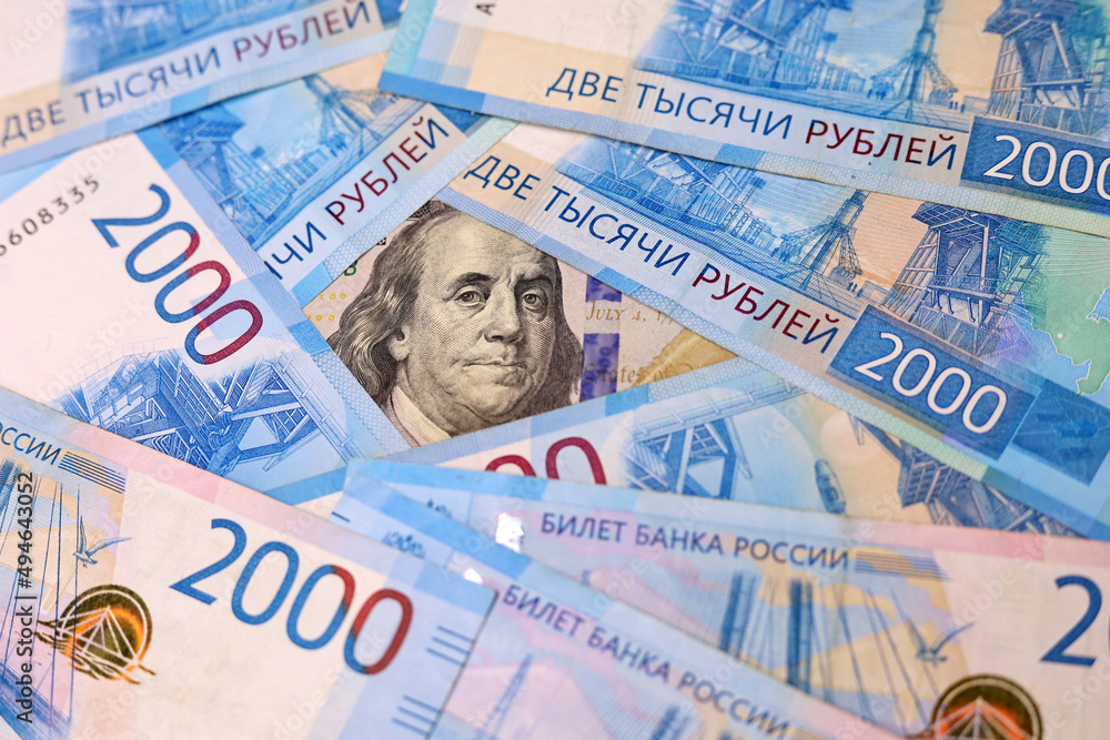 Fototapeta premium US dollar surrounded of russian rubles. Concept of exchange rate, american sanctions against Russia