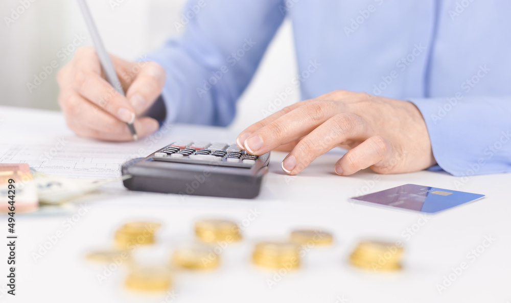 Woman's hand on calculator. Management of expenses, taxes Woman's hand on calculator. Management of expenses, taxes