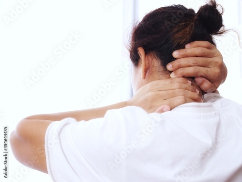 Asian woman with back ache, shoulder and neck pain or occipital muscle pain.