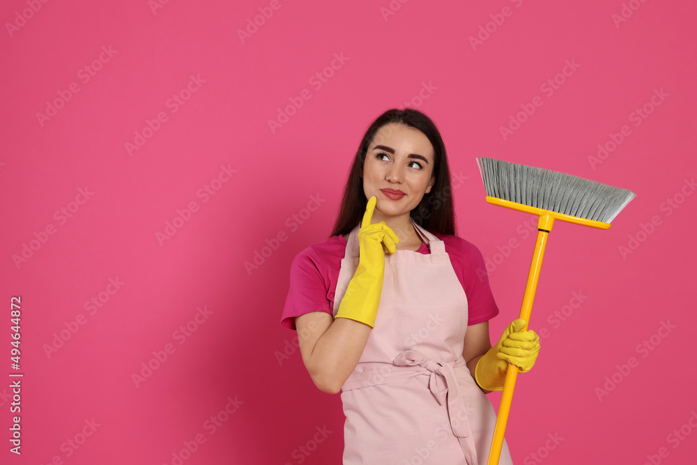 Beautiful young woman with broom on pink background. Space for text Beautiful young woman with broom on pink background. Space for text