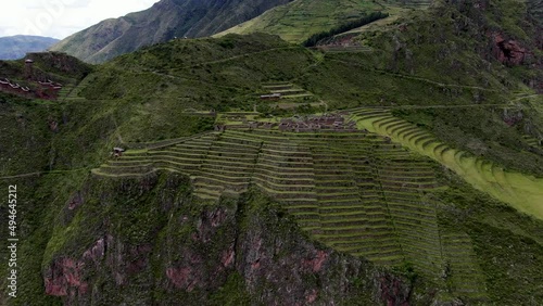 Towering Mountains With Farm Terraces In Pisac Ruins, Sacred Valley Of The Incas In Peru. Aerial Drone Shot photo