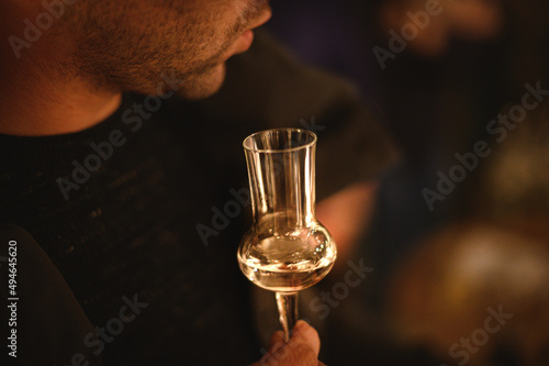 Photography hand with a glass of grappa wine at a tasting