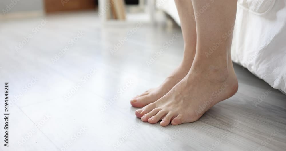 Legs of beautiful girl get up from bed by window Legs of beautiful girl get up from bed by window