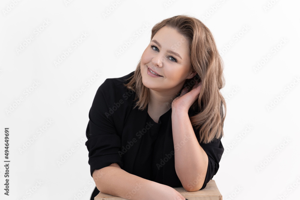 Portrait of smiling middle-aged fat overweight woman titivating long dark hair wearing black cardigan, sitting at table. Portrait of smiling middle-aged fat overweight woman titivating long dark hair wearing black cardigan, sitting at table.