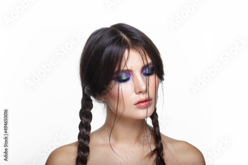Closeup face of a beautiful woman with a smoky eye makeup. Sexy and gorgeous brown-haired woman, isolated white background.