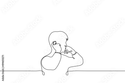 man installs hearing aid, wireless earpiece, ear microphone - one line drawing vector. ear accessories concept
