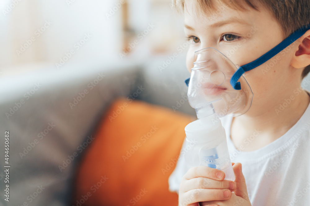 Little boy in mask from nebulizer close-up.