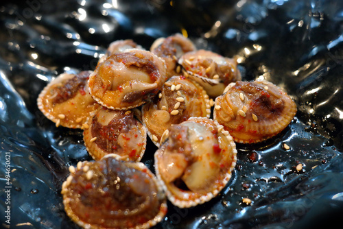 It is a Korean food that is boiled cockles, seasoned with vegetables and red pepper powder, and eaten sweet and sour. photo