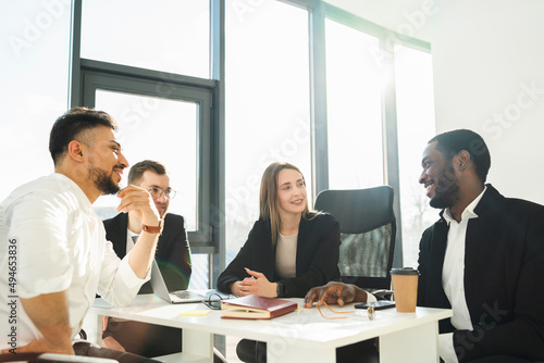 Multiracial office workers at morning meeting in office